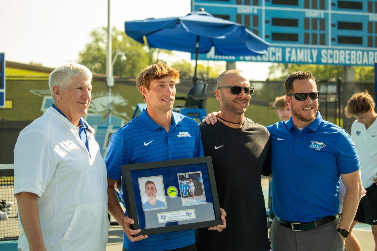 Ondrej Horak poses for senior day with MTSU athletic department members between matches at the MTSU Tennis Complex on April 10, 2026. 