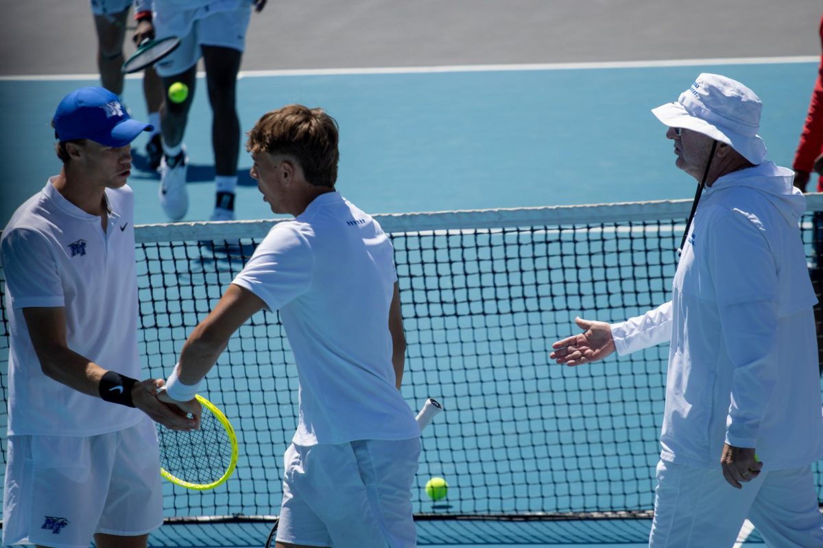 Jonasz Dziopak (left), Eric Crevei (middle) and assistant coach John Kreis (right) high five after picking up a point during the CUSA men's tennis championships against Liberty University at the Outdoor Tennis Complex on April 19, 2026. 