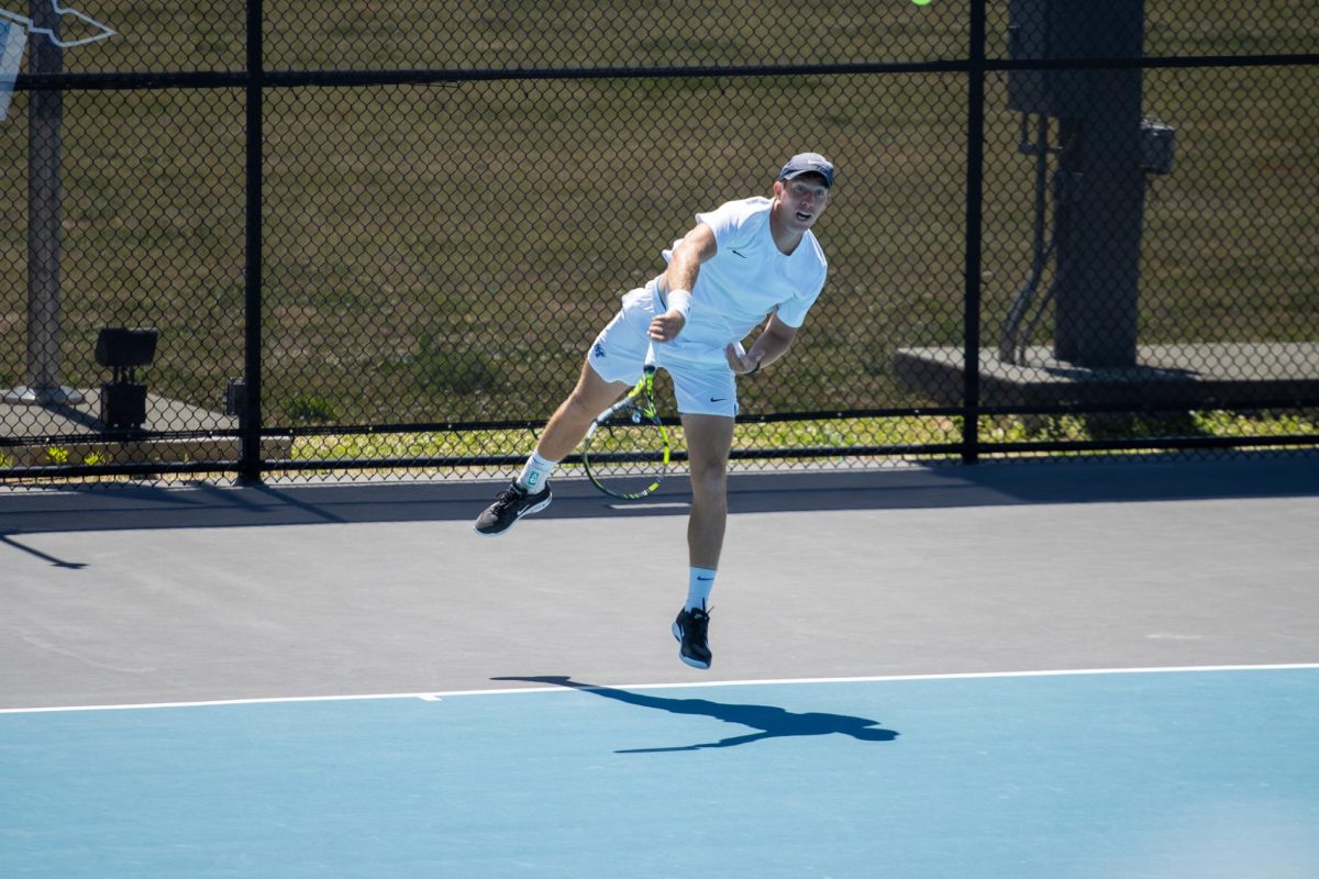 Ondrej Horak hits an overhead slam on his way to claiming victory for the Blue Raiders at the Outdoor Tennis Complex on April 19, 2026. 
