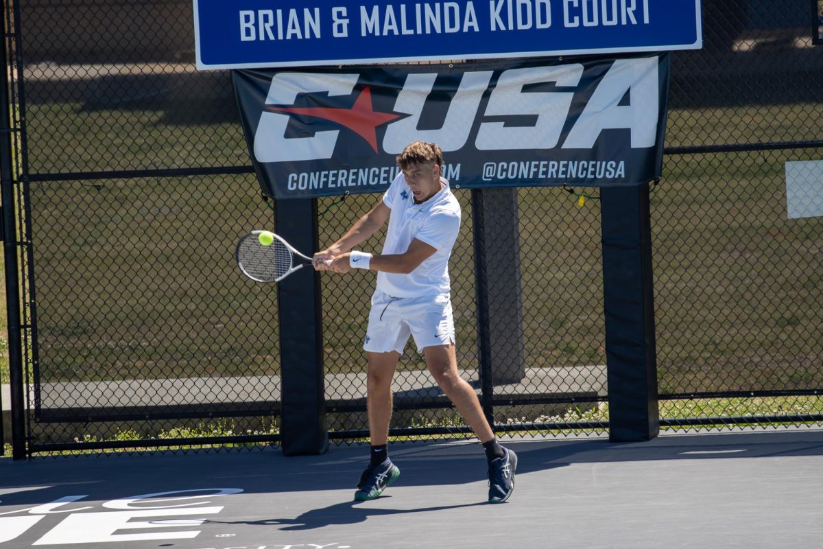 Eric Crivei returns a shot with a backhand in singles during the CUSA men's tennis championships against Liberty University at the Outdoor Tennis Complex on April 19, 2026. 