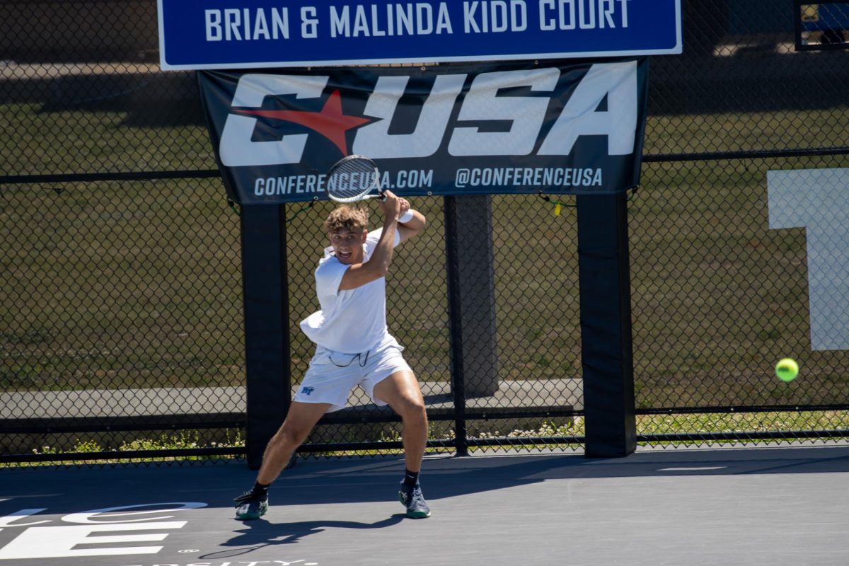 Eric Crevei returns a volley with a backhand shot during the CUSA men's tennis championships against Liberty University at the Outdoor Tennis Complex on April 19, 2026. 