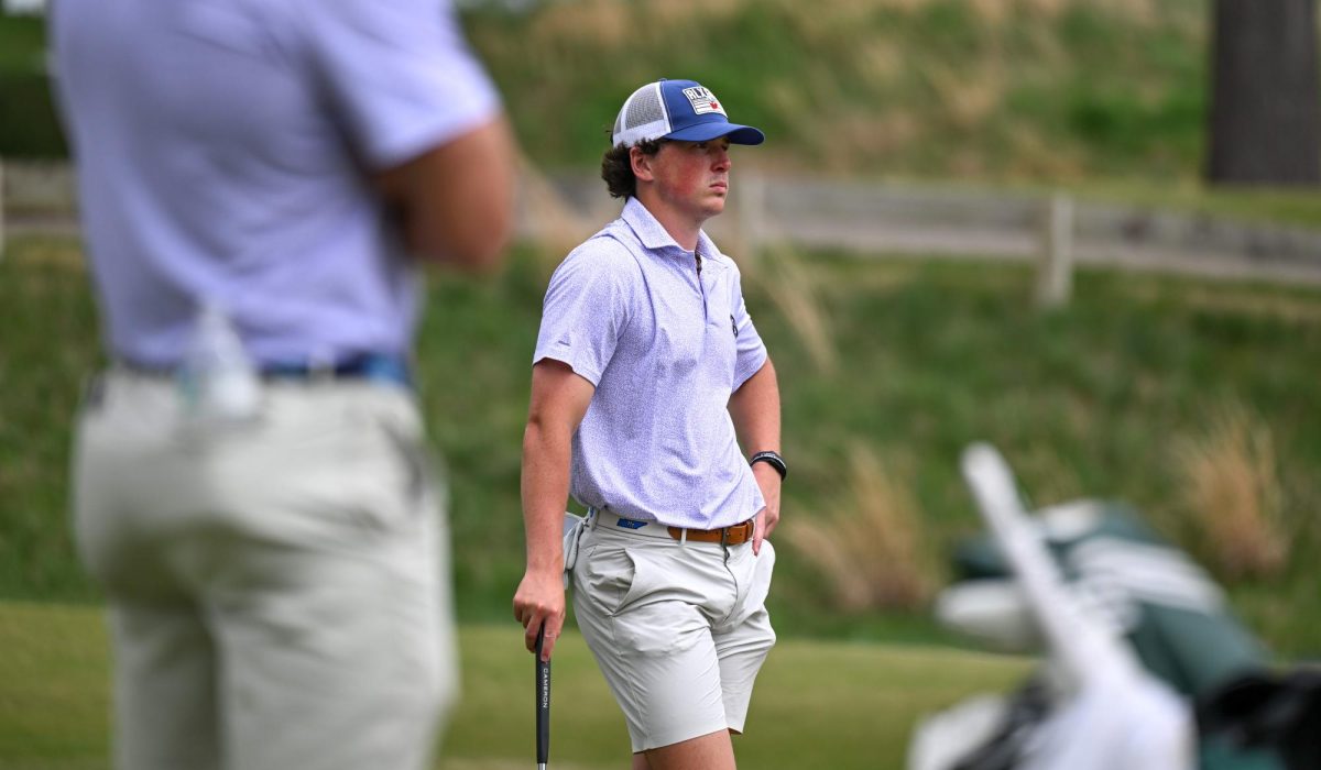 MTSU golfer Owen Queener looks on as another golfer putts during the Mason Rudolph Weekend tournament at the Vanderbilt Legends Club golf course. 