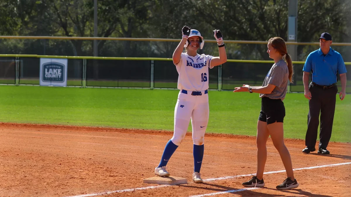 MTSU assistant coach Gretchen Mead celebrates with MTSU infielder Jana Watt after reaching first base. 