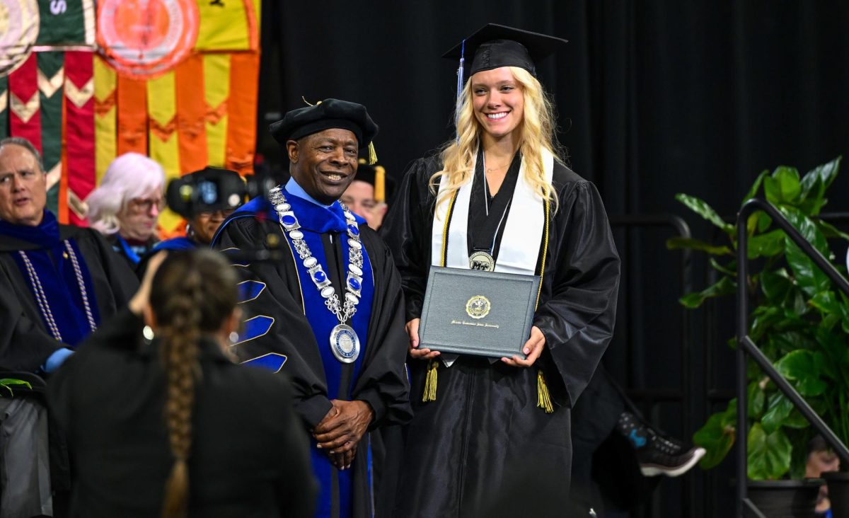 MTSU President Sidney A. McPhee (left) and graduate Payton Deidesheimer (right) during spring commencement inside the Murphy Center on May 9, 2026.