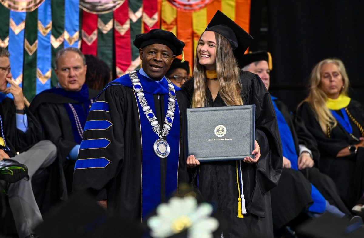 MTSU President Sidney A. McPhee (left) and graduate Brianna Barker pose for a picture during spring commencement inside the Murphy Center on May 9, 2026.