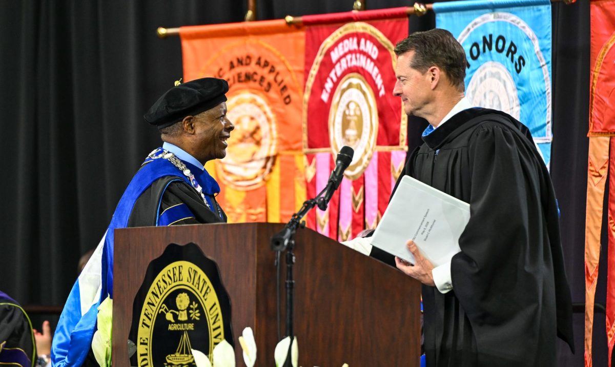 MTSU President Sidney A. McPhee (left) and Deputy Governor and Commissioner of the Tennessee Department of Economic and Community Development Stuart McWhorter (right) shake hands after the keynote speech during spring commencement inside the Murphy Center on May 9, 2026.