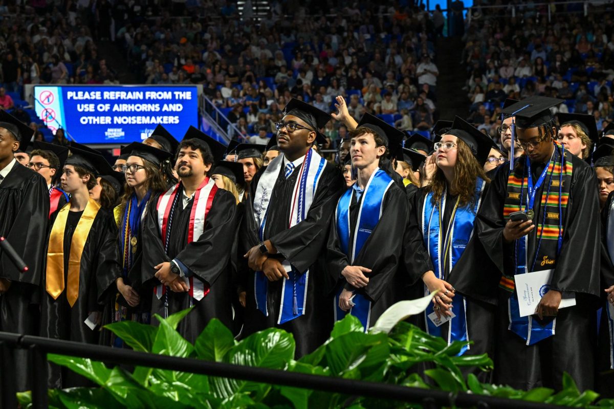Graduates stand during the opening of the 2026 spring commencement inside the Murphy Center on May 9, 2026.