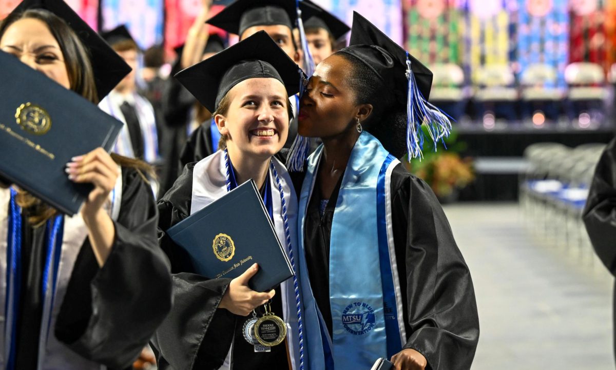 MTSU graduate Faith Batane (right) and Elizabeth Baxter (left) celebrate while walking off the Murphy Center floor during spring commencement on May 9, 2026.