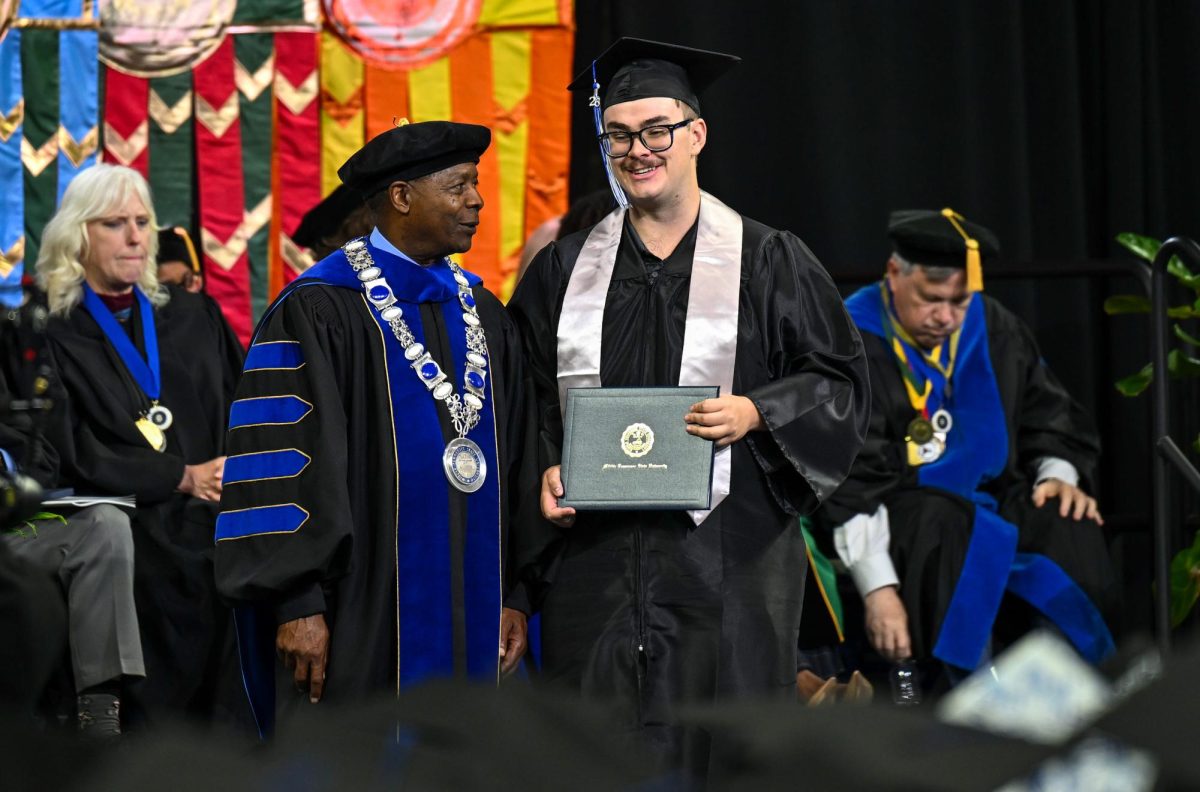 MTSU graduate William Phaler (right) and MTSU president Sidney A. Mcphee (left) pose for a picture during spring commencement inside the Murphy Center on May 9, 2026.