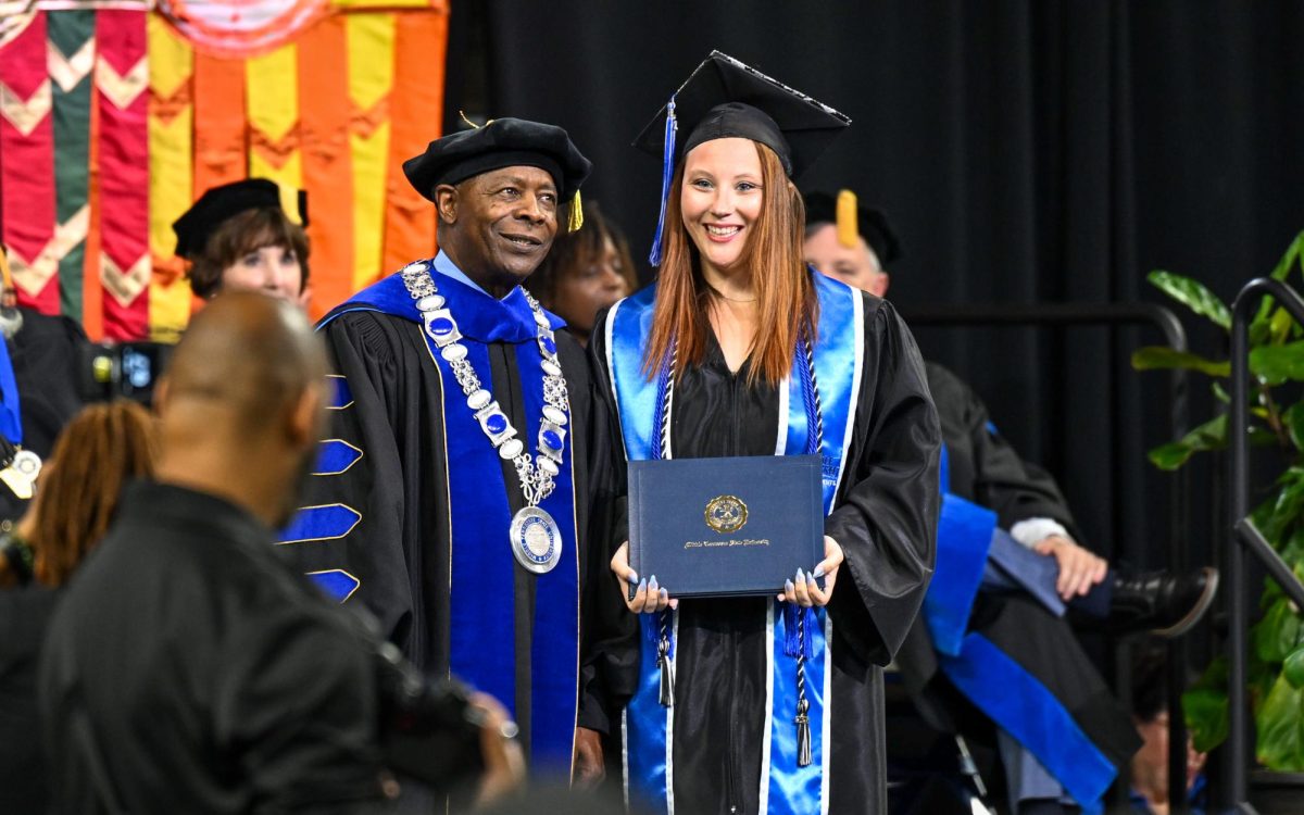 MTSU president Sidney A. Mcphee (left) and MTSU Sidelines Multimedia editor Caitlyn Hajek (right) during spring commencement inside the Murphy Center on May 9, 2026.