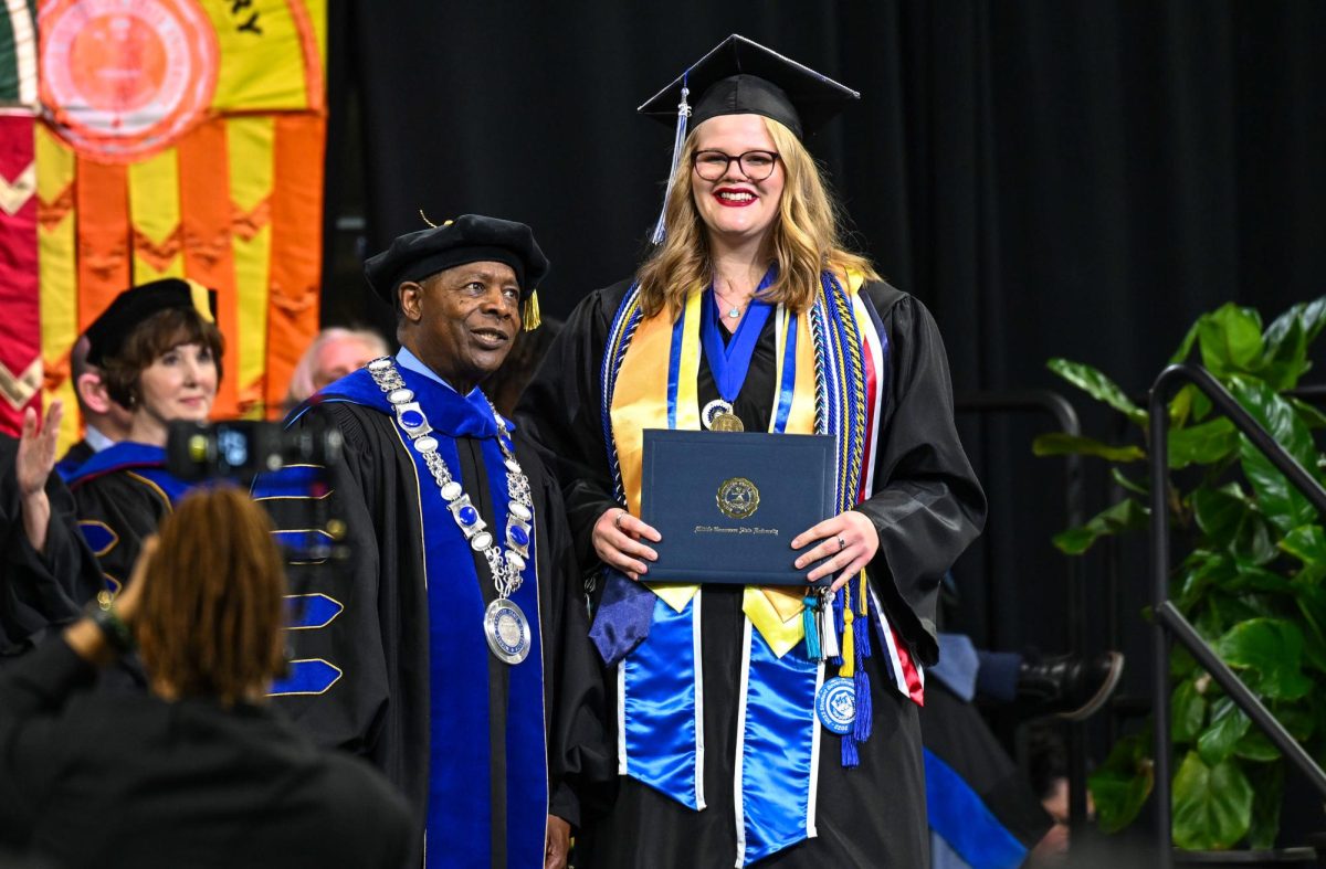 MTSU president Sidney A. Mcphee (left) and MTSU Sidelines Editor-in-chief Jenene Grover (right) during spring commencement inside the Murphy Center on May 9, 2026.