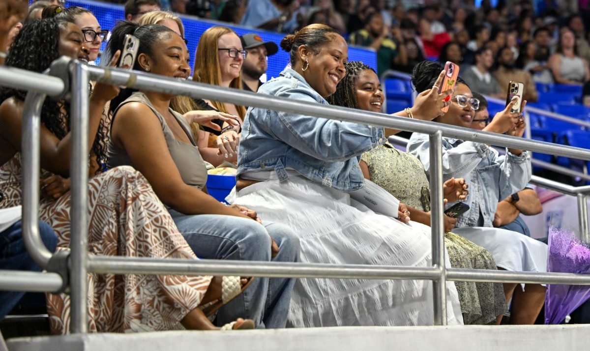 Family members of a graduate take pictures during spring commencement inside the Murphy Center on May 9, 2026.