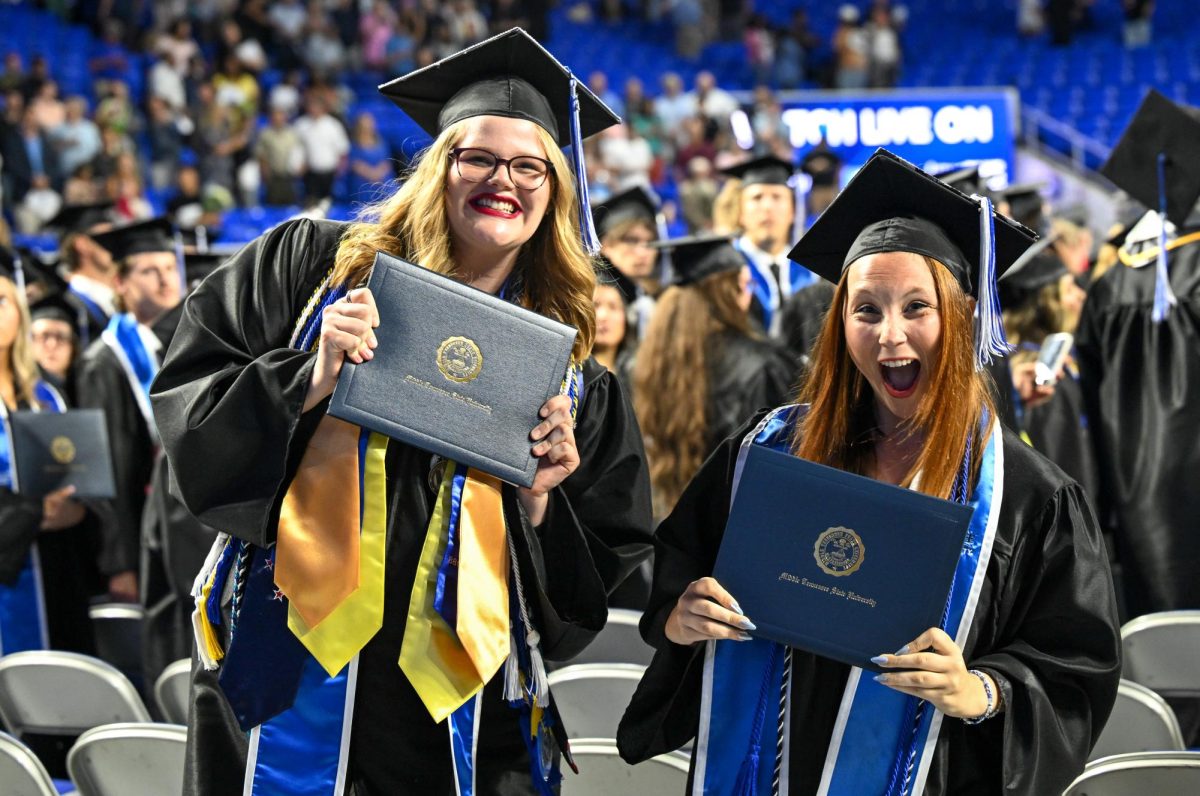 MTSU Sidelines Editor-in-chief Jenene Grover and Multimedia editor Caitlyn Hajek celebrate earning their degrees during spring commencement inside the Murphy Center on May 9, 2026.