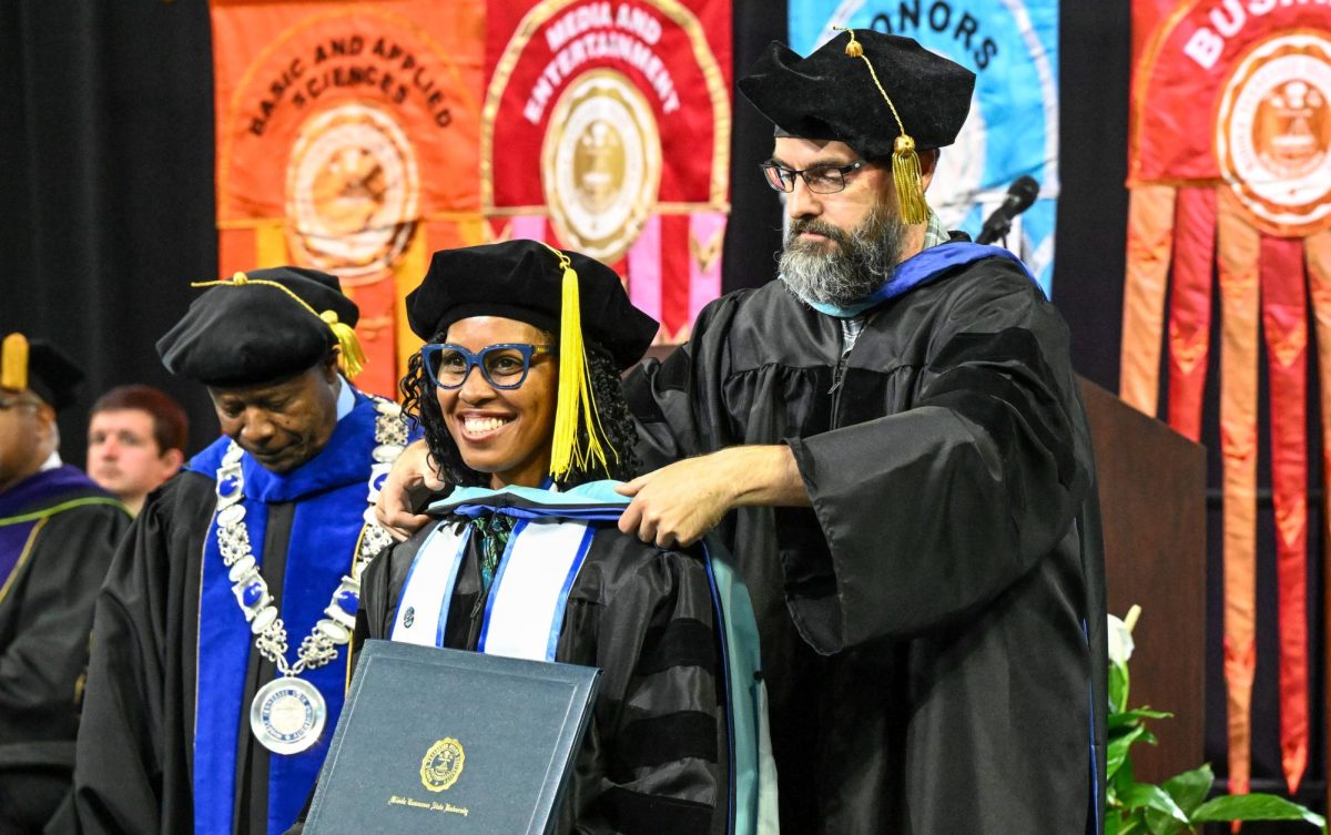 MTSU Doctor of Education graduate Ayana Samuel is hooded during spring commencement inside the Murphy Center on May 9, 2026.