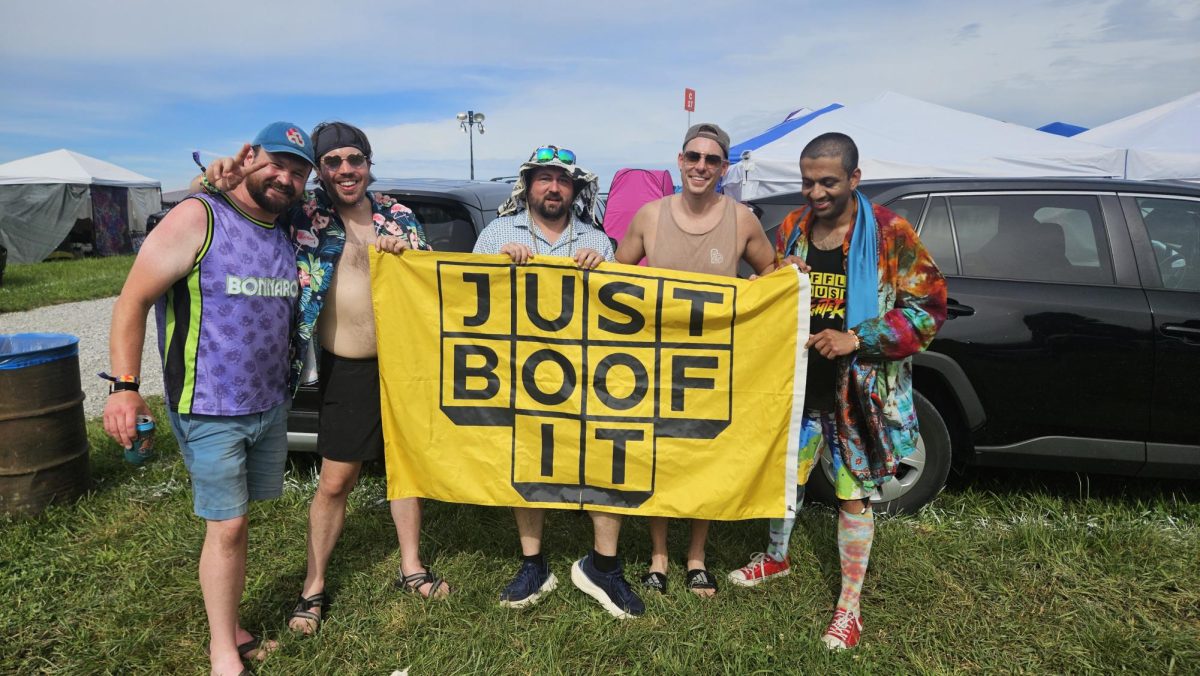 Just Boof It members Seth Rickard, Matt Gregg,  Keith Arnold, David Fitzgibbons and Akash Gondalia hold the camp flag at Bonnaroo Music & Arts Festival in Manchester, Tennessee, on June 12, 2026. 