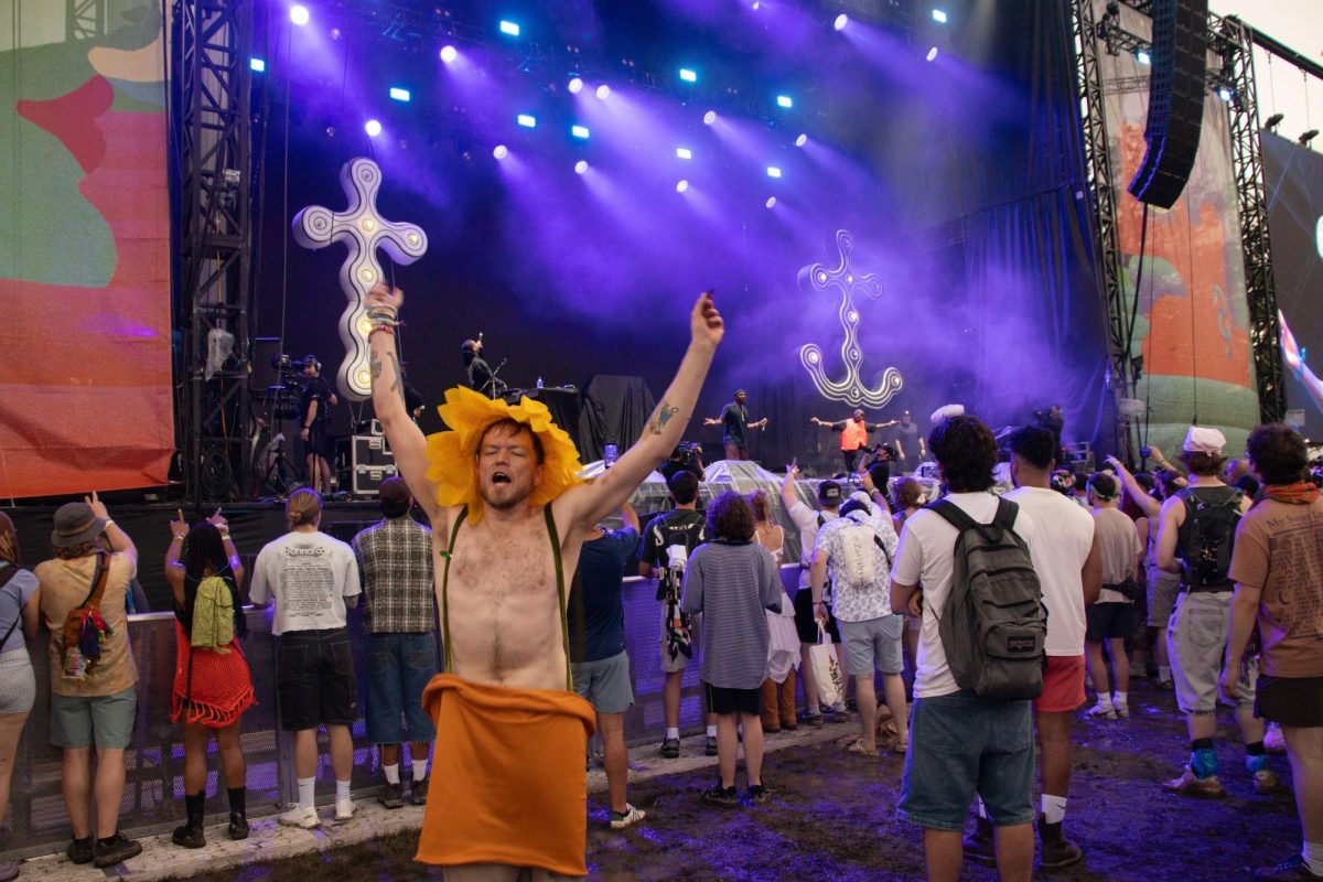 Fan cheers as Clipse performs on the Which Stage at Bonnaroo Music & Arts Festival 2026. 