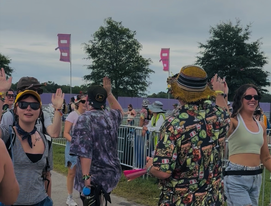 Bonnaroovians celebrate high five Friday at Bonnaroo Music & Arts Festival in Manchester, Tennessee, on June 12, 2026.